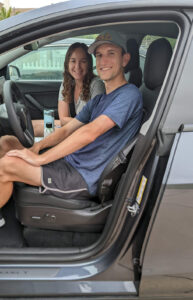 Brad and Courtney Borodaty sitting in their car prepared to leave