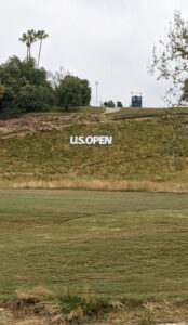 US Open sign on the hillside below the 4th tee at Los Angeles Country Club